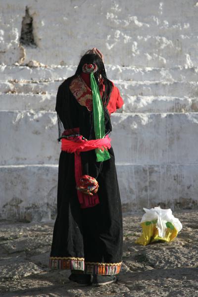 Woman praying at Ganden monastery | Ganden Monastery | China