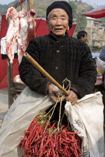 Old woman selling chillies - note the holes in her ears | MarchÃ© de Gedong | Chine