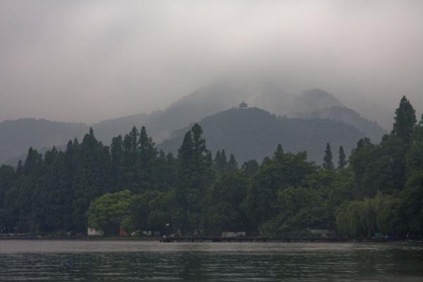 Western coast of the West Lake with mountains disappearing in the fog | West Lake | China