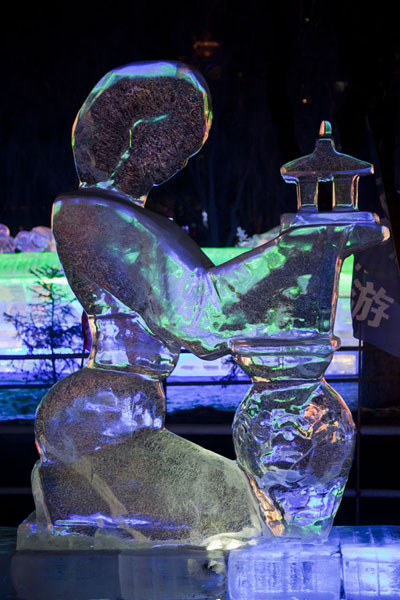 Elegant lady holding a Chinese building in her hands, Ice Lantern Art Show, China