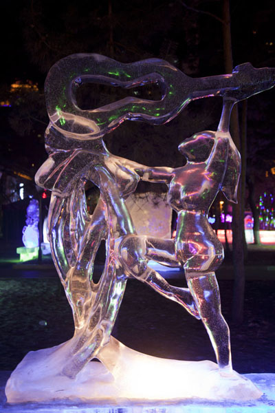 Ice sculpture of woman with instrument, Ice Lantern Art Show, China