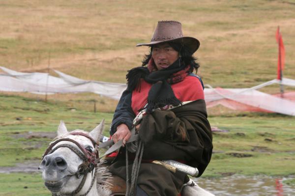 Khampa horserider in the vicinity of Tagong, China Khampa man horseriding in the vicinity of Tagong, China