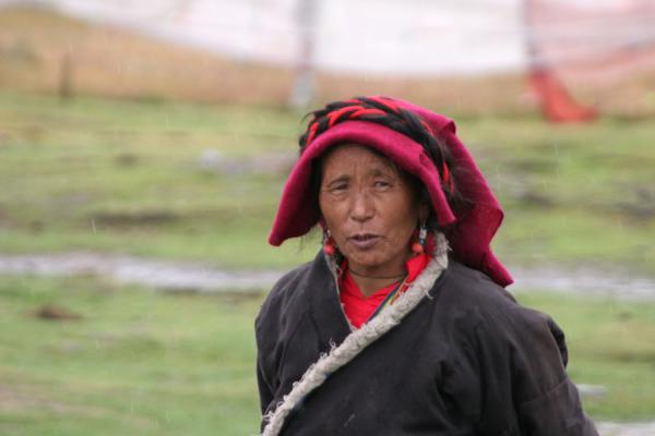 Old Khampa woman in the countryside, braving the elements, China