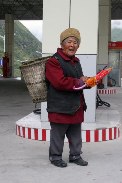 Old woman in a gas station, China
