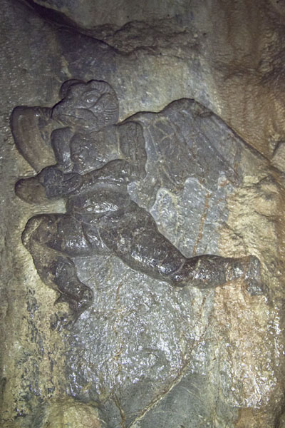 Foto di Close-up of a winged figure sculpted out of a wall inside a cave at the Lingyin temple complexHangzhou - Cina