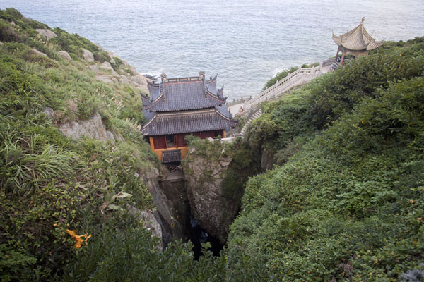 Temple at Fanyin Cave, straddling a narrow chasm in which the waves produce chant-like sounds | Putuoshan | China