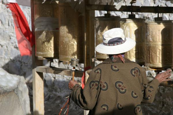 Pilgrim setting the prayer wheels in motion on Tashilhunpo kora, China