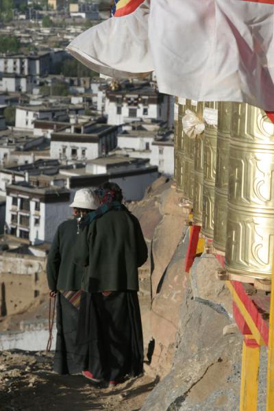 Two female pilgrims walking down the Tashilhunpo kora, China