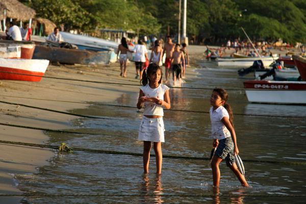 Girls with fish at the beach of Taganga, Colombia