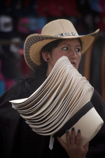 Woman selling hats at the market of Villa de Leyva, Colombia Market woman with hats in Villa de Leyva, Colombia