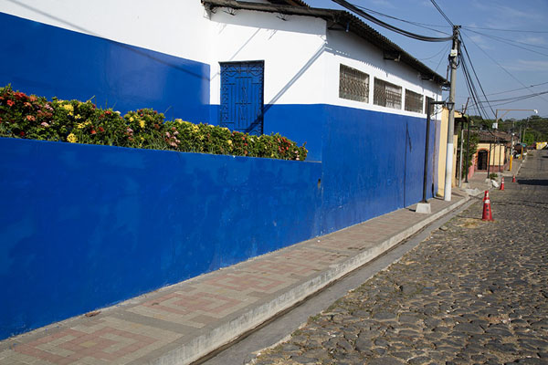 School building with flowers on a cobble-stone street in Nahuizalco, Nahuizalco, El Salvador