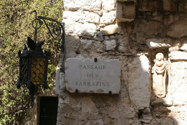Streetscene in Eze: lantern, street sign and sculpture in the wall | Eze | la France