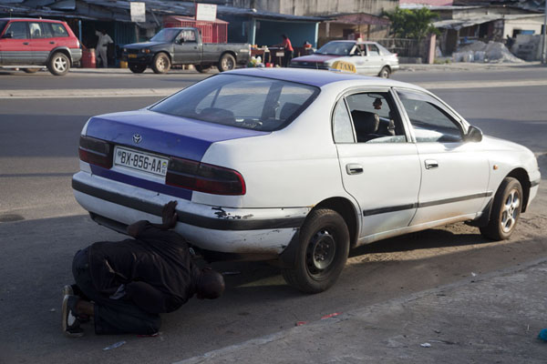 Driver fixing his taxi | Libreville taxi drivers | Gabon