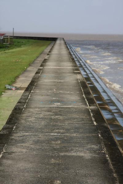 This stretch of the Georgetown seawall is broad enough to walk on, Guyana The Georgetown seawall closely follows the coastline, Guyana
