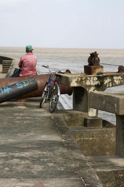 Sitting on the seawall, Guyana