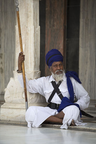 Sikh with long wooden stick with metal point at Gurudwara Bangla Sahib | Gurudwara Bangla Sahib | India