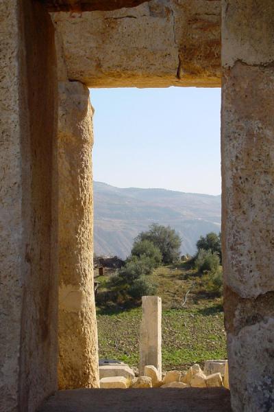 Peering through a window at Qasr al-Abd, Wadi Seer, Jordan