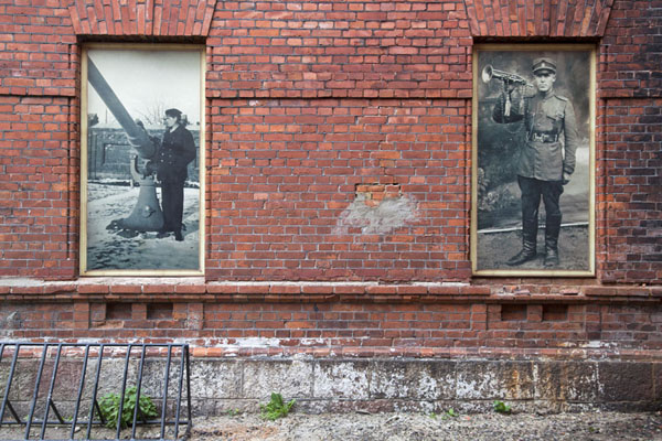 Old black-and-white pictures on a wall of the former military prison of Karosta, Latvia