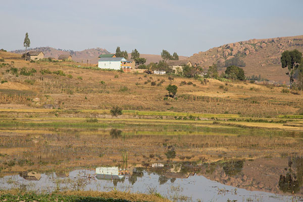 Houses reflected in lake near Anja | Anja | Madagascar