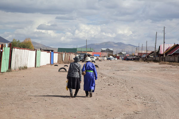 Two Mongolian women walking a street of Mörön, Mörön, Mongolia