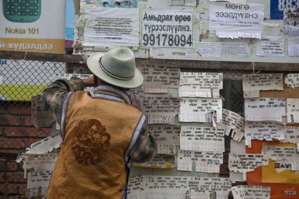 Mongolian man managing a message board at the market of Mörön, Mörön, Mongolia