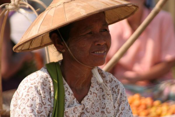 Woman with typical hat at a street market, Myanmar