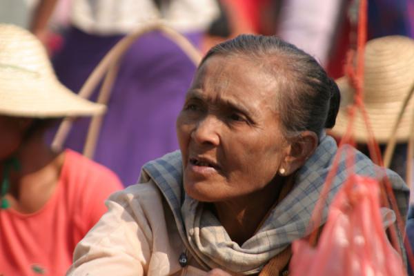 Old burmese woman buying some things in the streets, Myanmar