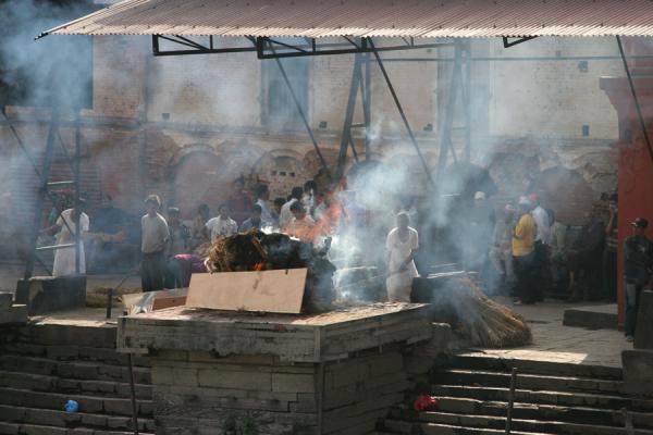 Picture of Taking care of the fire of a burning corpse at PashupatinathKathmandu - Nepal