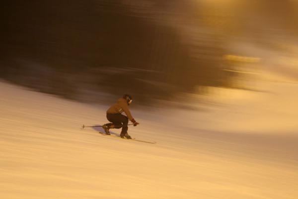 Telemark skier going down a slope at Tryvann | Tryvann skiing | Norway