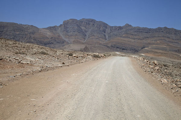 Gravel road with Jebel Harim in the background | Musandam mountains | Oman