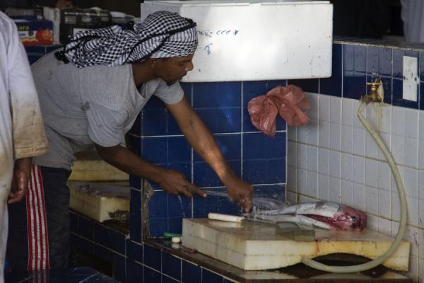 Cleaning and cutting fish, Oman