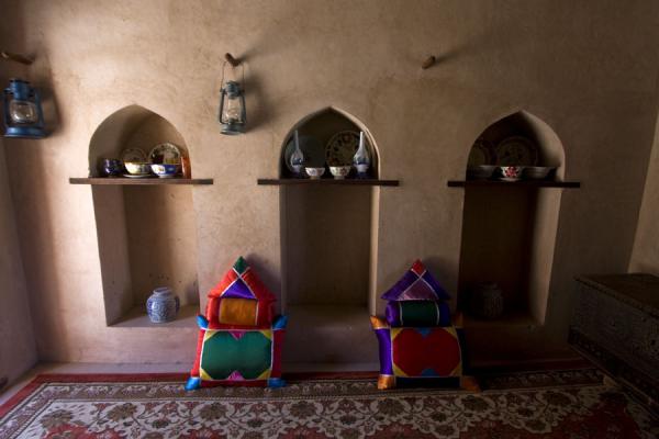 Picture of Pillows and oil lamps on a side wall of a room inside Nakhal FortNakhal - Oman