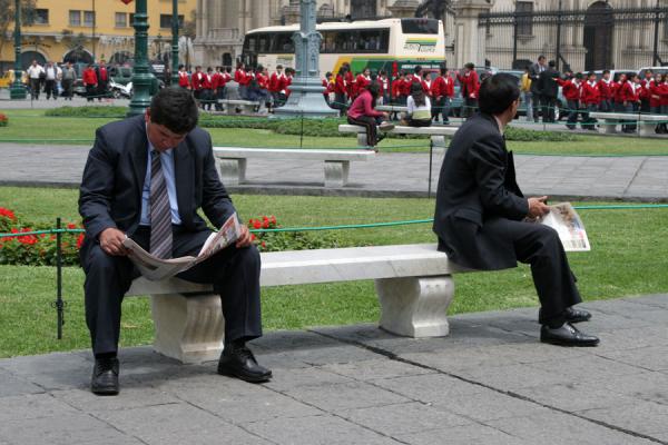 Two men having a break on a bench on the Plaza de Armas, Peru