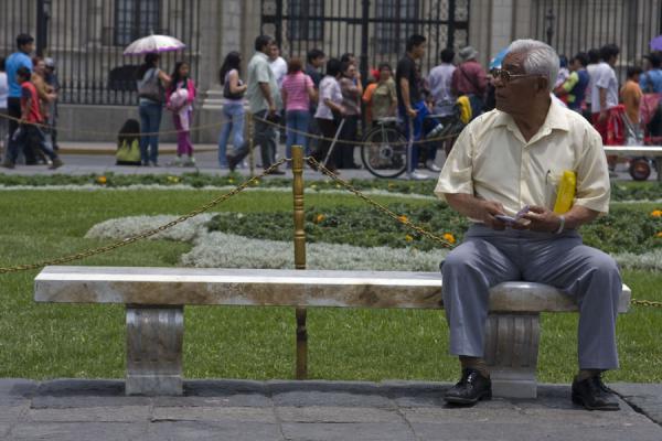 Old man on a bench of Plaza de Armas, Peru