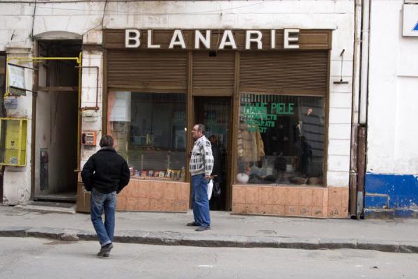 Men chatting in front of one of the traditional shops of the historic quarter, Lipscani historic quarter, Romania