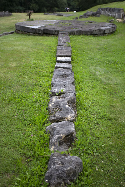 Arrow of the andesite altar in the background, Sarmizegetusa Regia, Romania