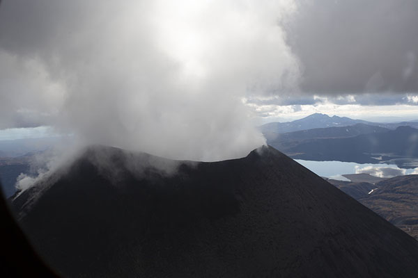 Constant pillar of smoke coming out of Karymsky volcano, Kamchatka from the air, Russia