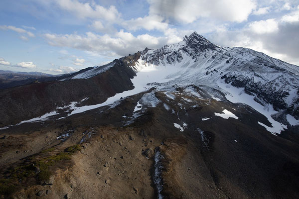 Snowy slopes of a mountain in Nalychevo park in central Kamchatka, Kamchatka from the air, Russia