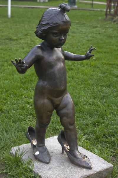 Girl trying high-heeled shoes in the Sculpture Park | Sculpture Park | Russia