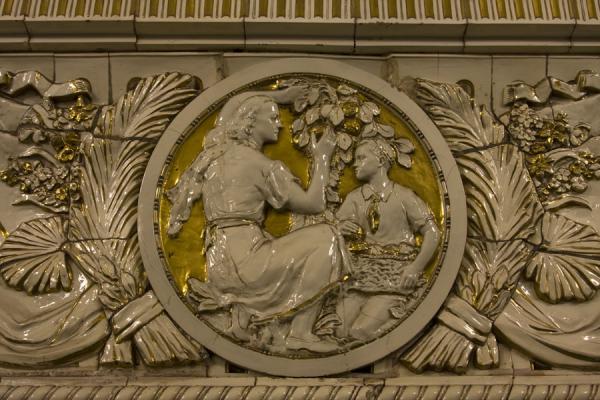 Detail of white porcelain with gold background at the Prospekt Mira subway station | Moscow subway stations | Russia