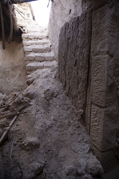 Ruins of house in the old town with crumbling walls and wooden door, Al Ula old town, Saudi Arabia