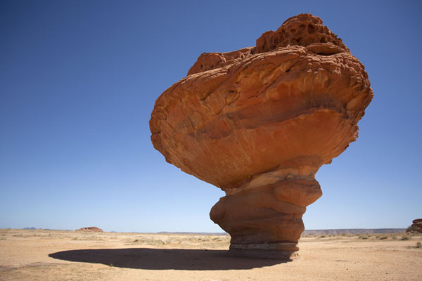 Mushroom rock casting a shadow on the ground, Saudi Arabia