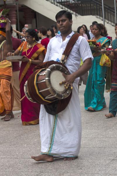 Man with instrument in a small procession in Sri Mariamman temple | Stazione Centrale di Milano | Italia