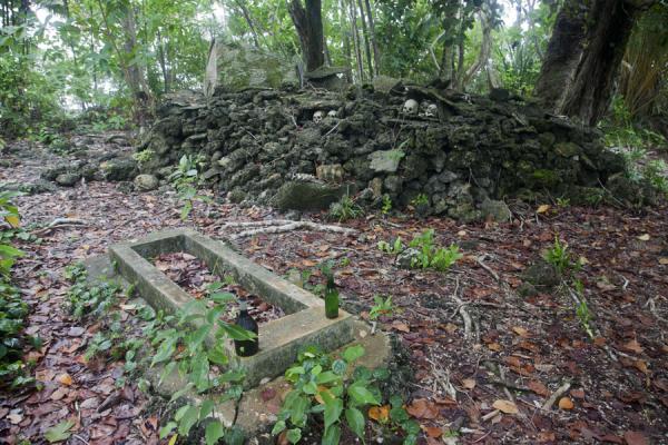 Picture of Tomb of the last person to prepare skulls the traditional way next to the shrine containing the skullsMunda - Solomon Islands