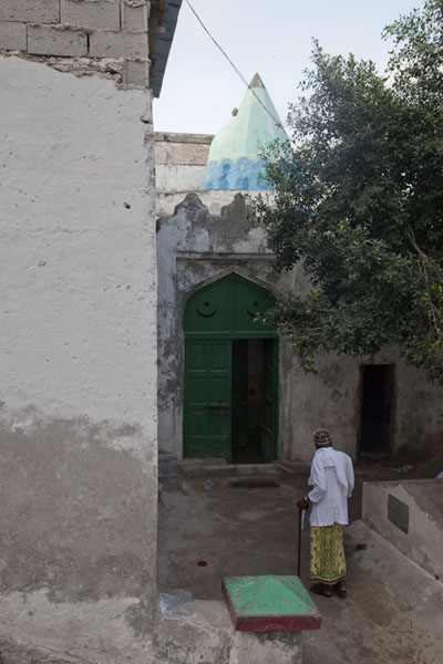 View of Fakr ad-Din mosque with the highest responsible leader walking towards it, Somalia