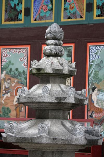 Stone pagoda with wooden panels of Great Hero Hall at Jogyesa, South Korea