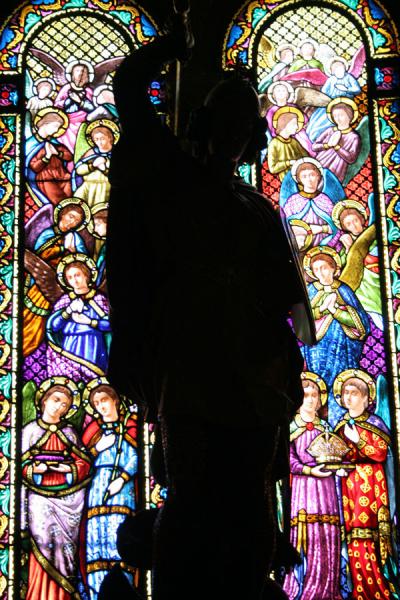 Silhouette of statue with stained glass in the background, Spain