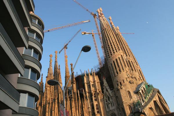 Sagrada Familia seen from a corner with modern building, Spain
