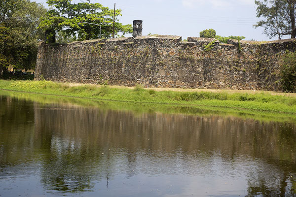 The wall of the old Dutch fort reflected in the surrounding moat | Batticaloa | Sri Lanka