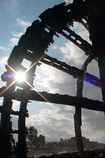 Sunlight through a noria in the city park in Hama, Norias, Syria